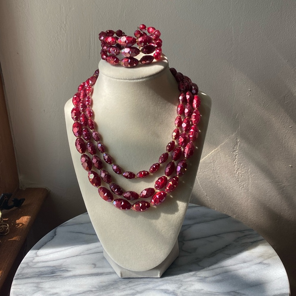 Signed Austria vintage three strand cranberry beaded necklace and bracelet set.